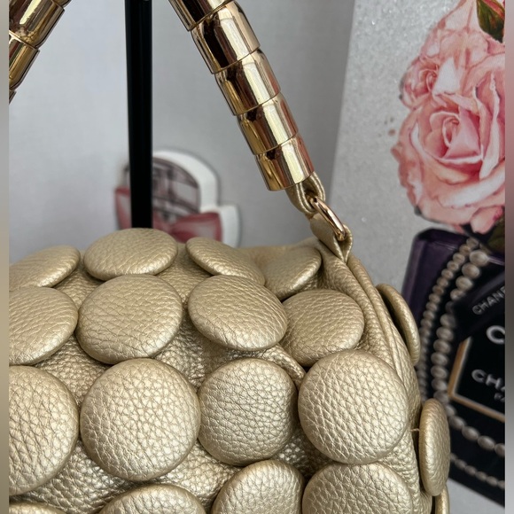 unique design with embossed circular details and a structured, metallic handle. - Picture 5 of 12